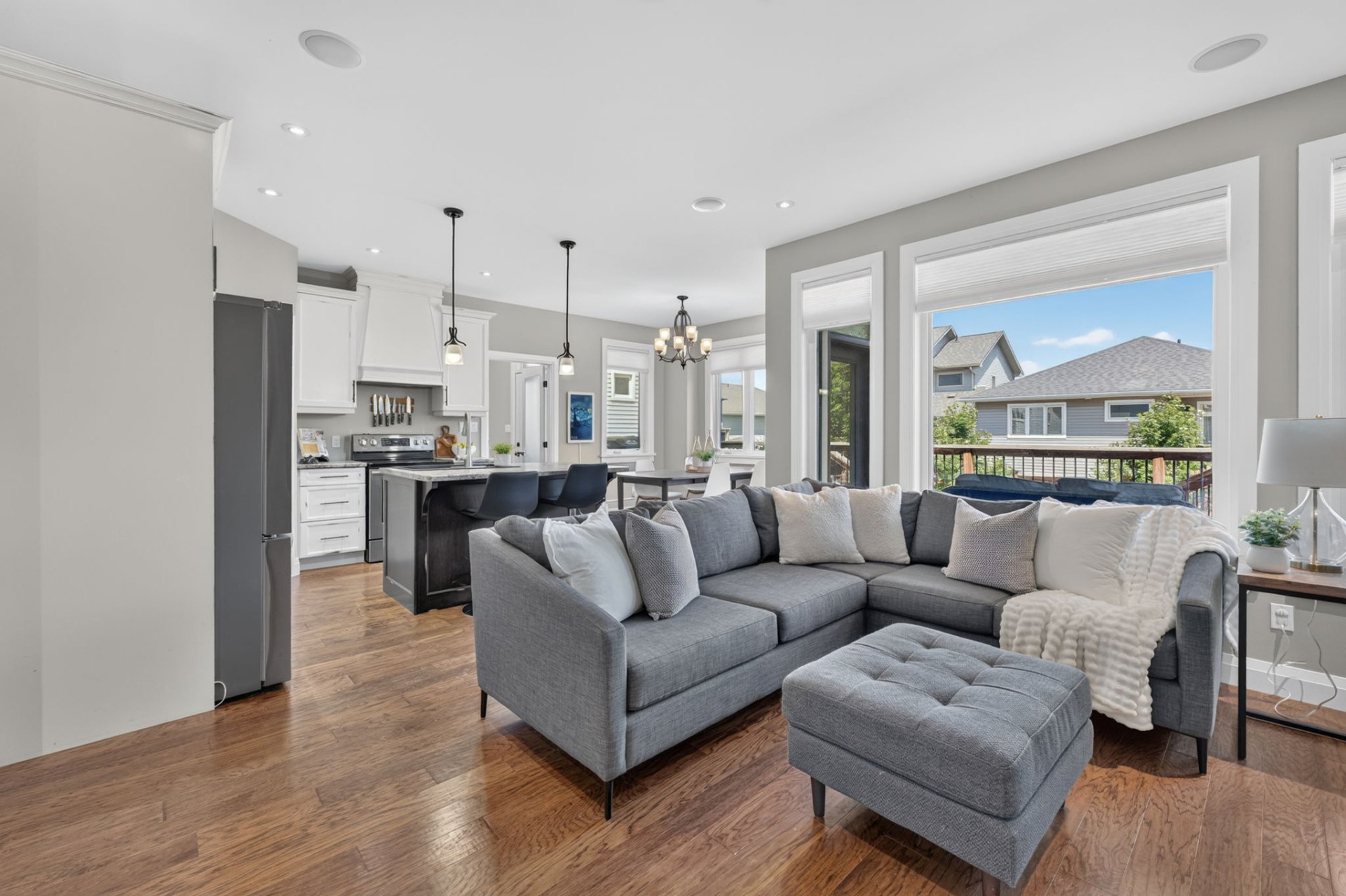 Sun-filled living room open to the kitchen