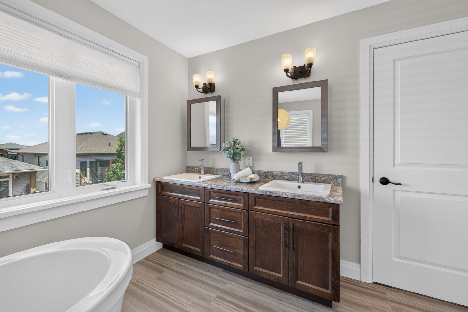 Freestanding soaker tub beneath the windows